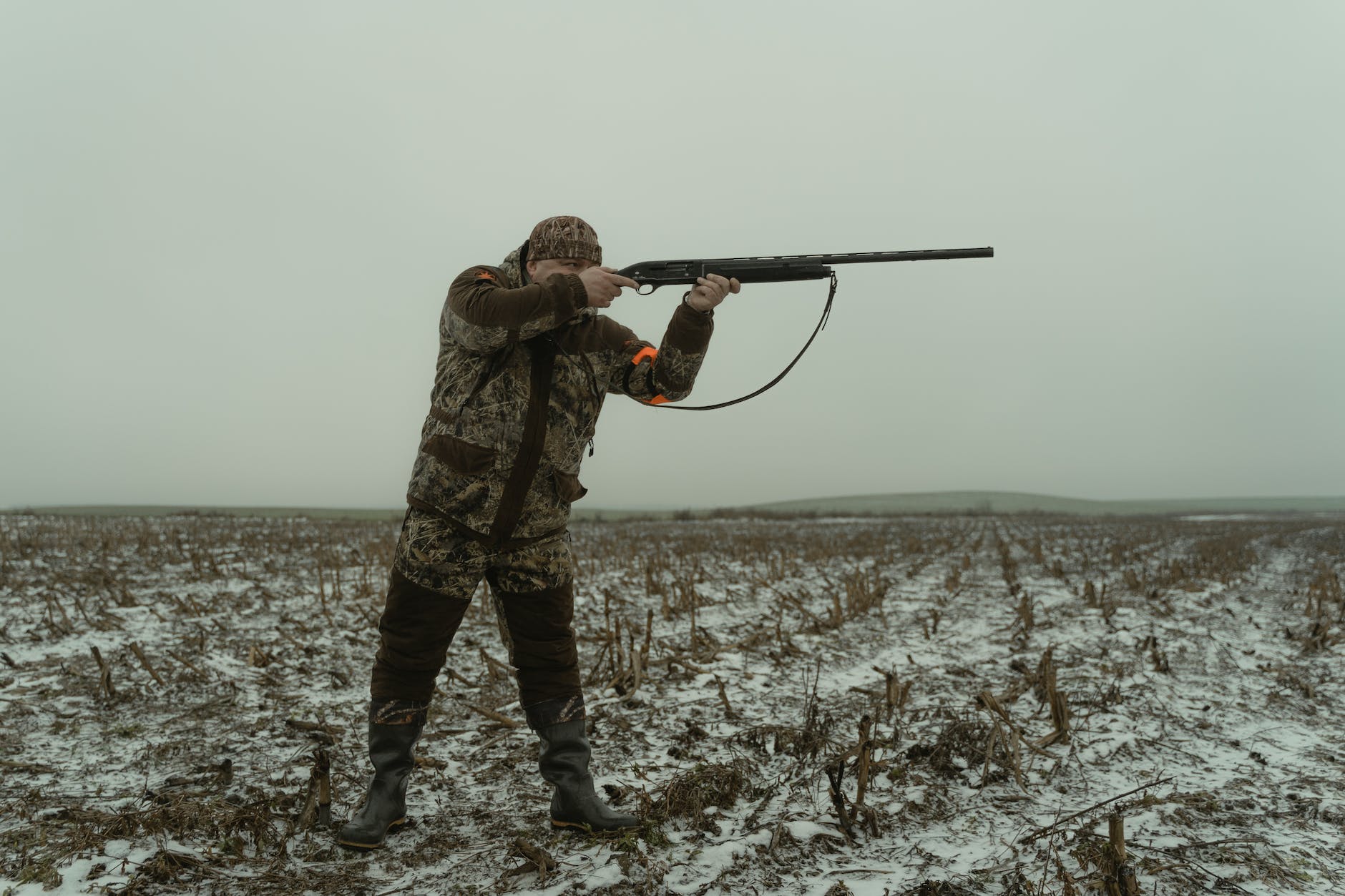 man shooting a shotgun