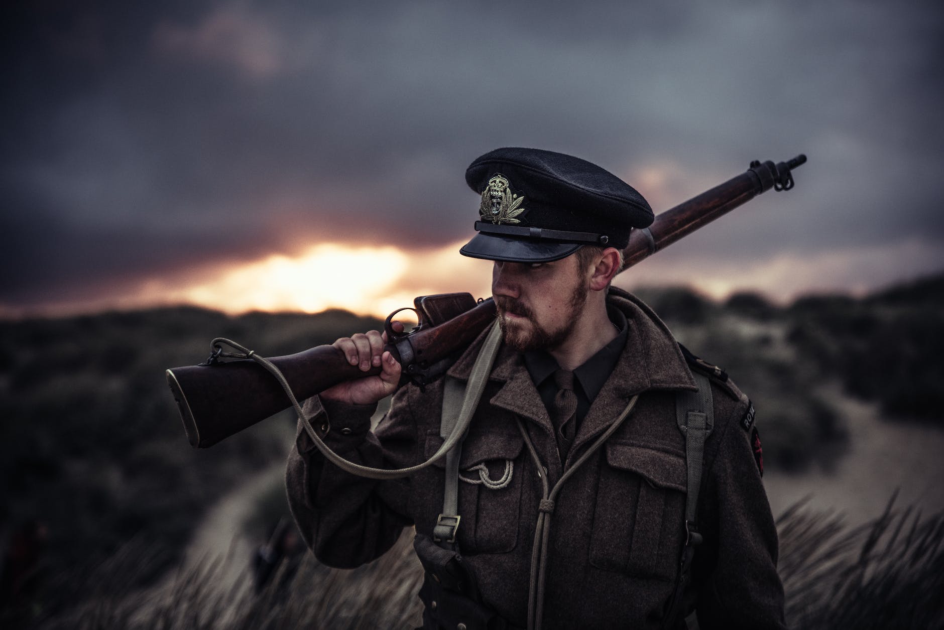 close up photography of a man holding rifle